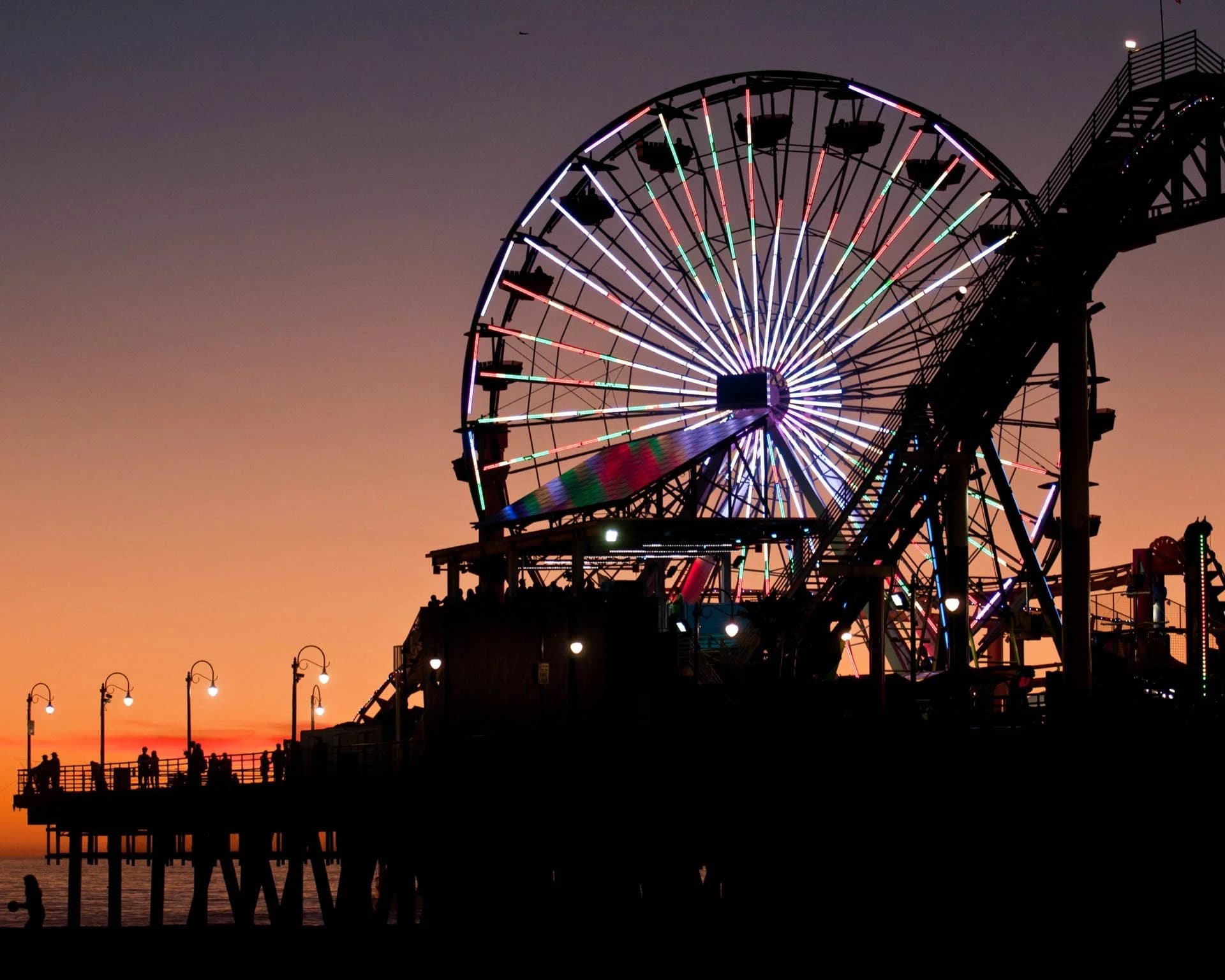 The Santa Monica Pier ferris wheel lit up at dusk